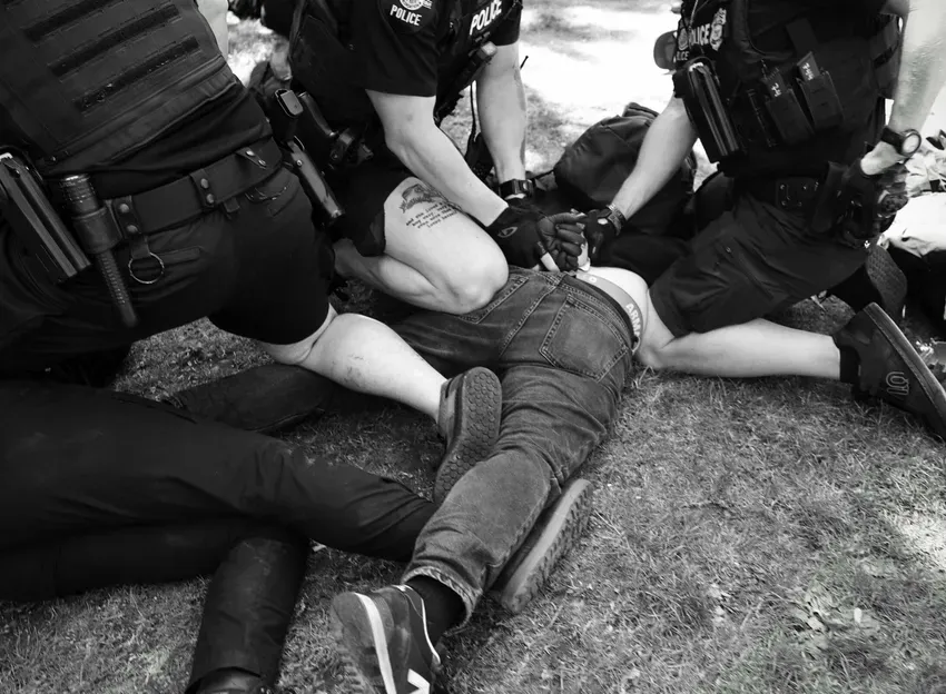 Seattle Police officers arrest counterprotesters after someone in the crowd popped a ballon. Photo by Hannah Saunders